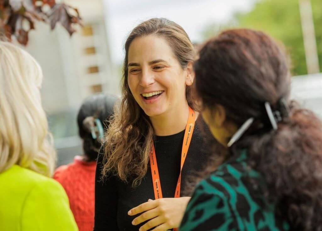 RCPI female trainee laughing while speaking to colleagues outside at Sligo University Hospital